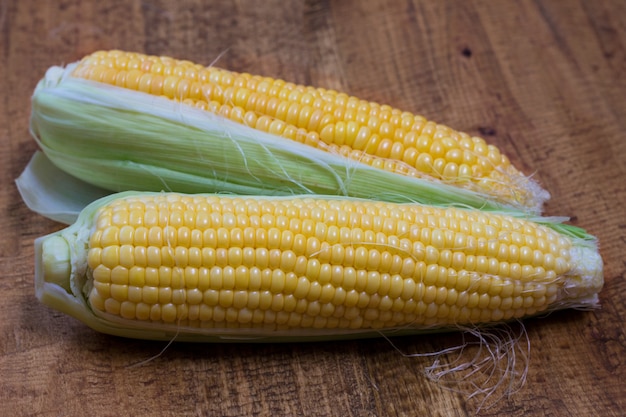 An ear of corn isolated on a wooden background