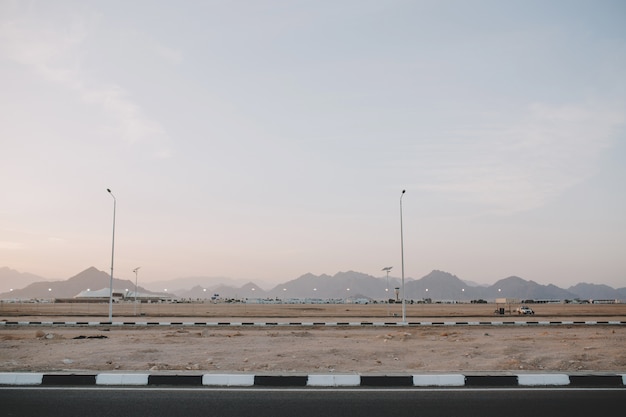 Free photo early morning sunrise, landscape with mountains on road of tropical counrty. blue sky, summer, nature, travelling far away.