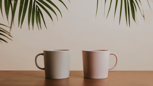 Free photo earth tone color ceramic coffee cups on wooden table