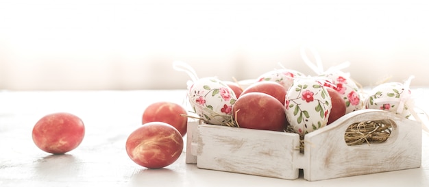 Free Photo easter background with a basket and red eggs with flowers