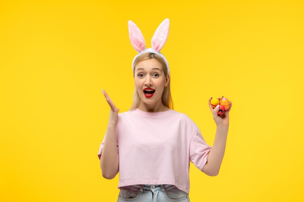 Easter beautiful cute blonde girl with bunny ears excited holding easter eggs