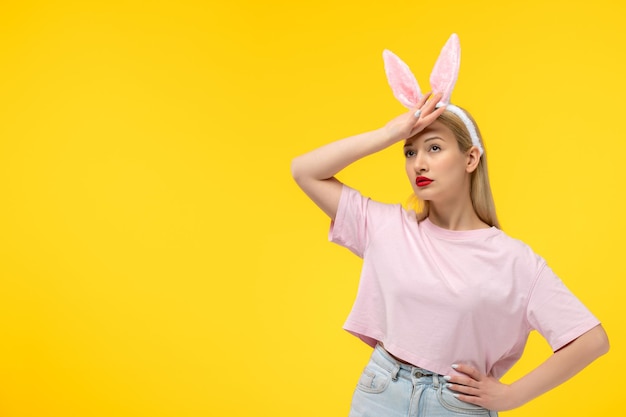 Easter beautiful cute blonde girl with bunny ears tired touching her forehead