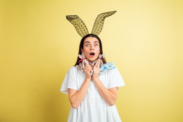 Free photo easter bunny woman with bright emotions on yellow