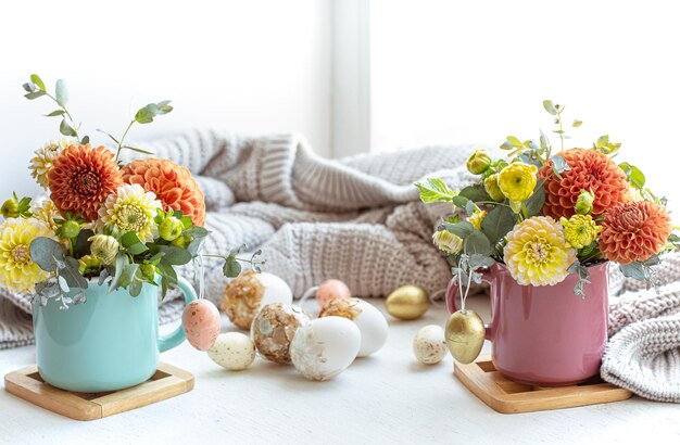 Easter composition with a bouquet of flowers and eggs on a blurred background