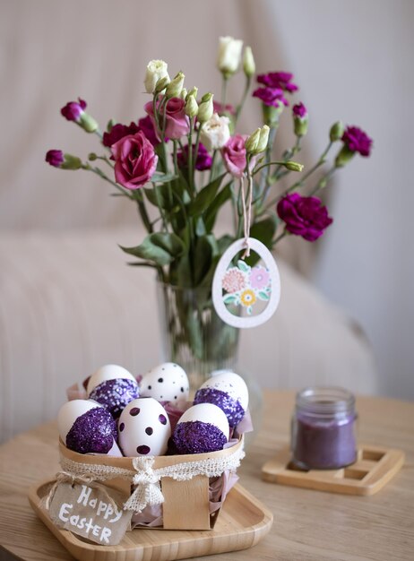 Easter composition with eggs decorated with purple sparkles