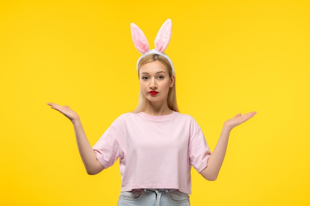 Easter cute young blonde girl wearing pink bunny ears with red lipstick waving hands