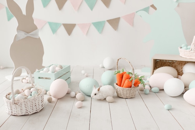 Easter decoration of the room, studio. Big wall with garland on background.