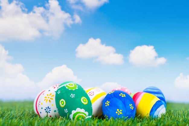 Easter Eggs on Fresh Green Grass over blue sky