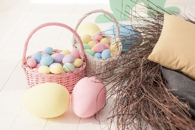 Easter eggs in the nest on rustic wooden background.