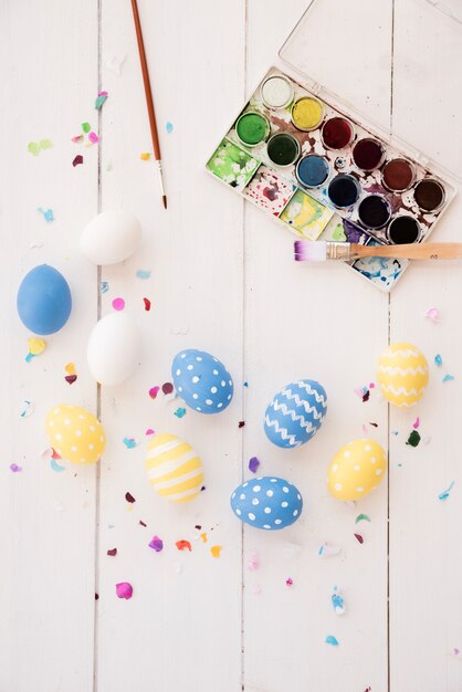 Easter eggs with paint palette and brushes 