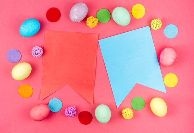 Easter eggs with paper flags on table