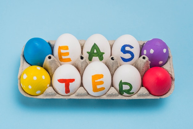 Free photo easter inscription on eggs in rack