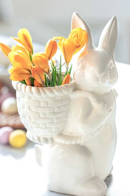 Free photo easter still life with a ceramic hare eggs and flowers