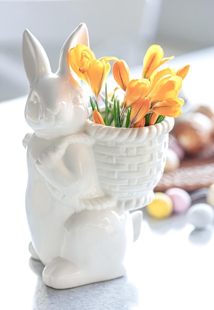 Free photo easter still life with a ceramic hare eggs and flowers