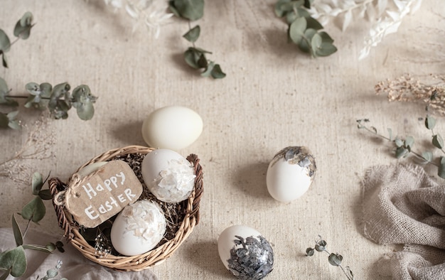 Easter still life with eggs in a wicker basket. Happy Easter concept.