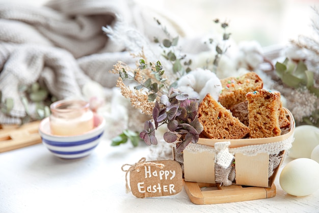 Free photo easter still life with pieces of festive cupcake, eggs and flowers. easter holiday concept.