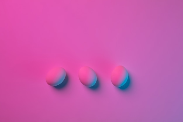 Easter traditions, pink-blue colored eggs on pink background