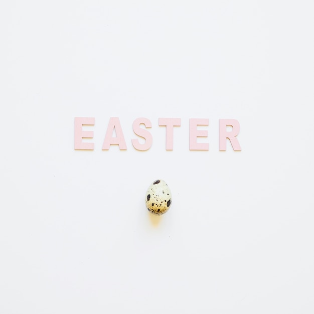 Free photo easter word and quail egg