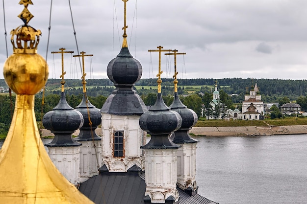 Eastern orthodox crosses on gold domes, cupolas, against blue sky with clouds. Orthodox church