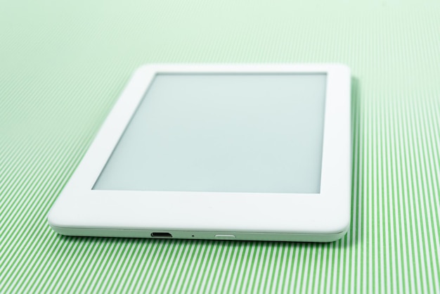 Ebook reader over green striped background