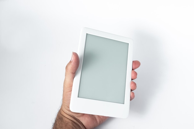 Free photo ebook reader over isolated white background  being held by a male hand