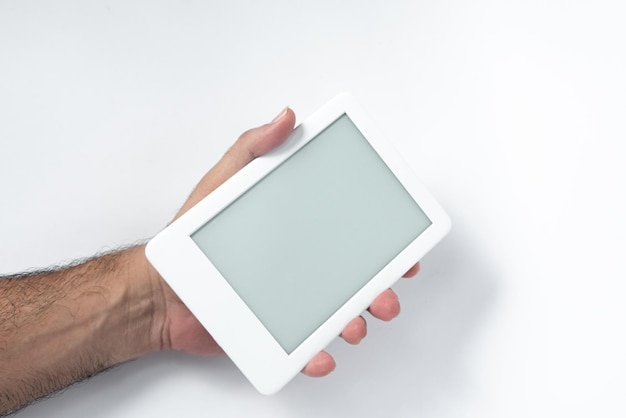 Free photo ebook reader over isolated white background  being held by a male hand