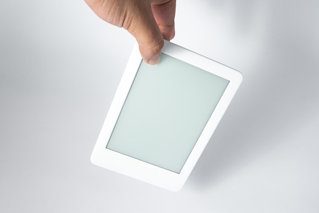 Free photo ebook reader over isolated white background  being held by a male hand