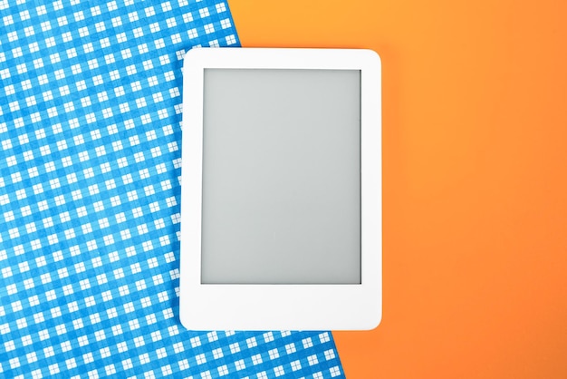 Ebook reader over yellow and blue background