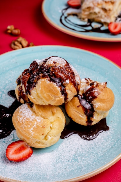 Eclairs topped with chocolate syrup