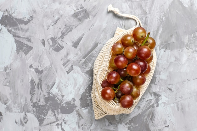 Eco-friendly simple beige cotton shopping bags for buying fruit and vegetables with summer fruits.