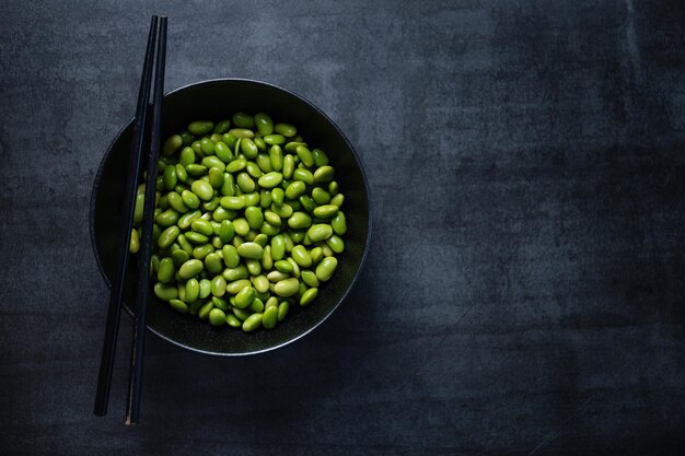 Edamame beans in bowl on dark