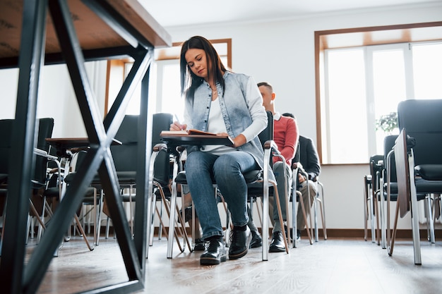 Education conception. Group of people at business conference in modern classroom at daytime