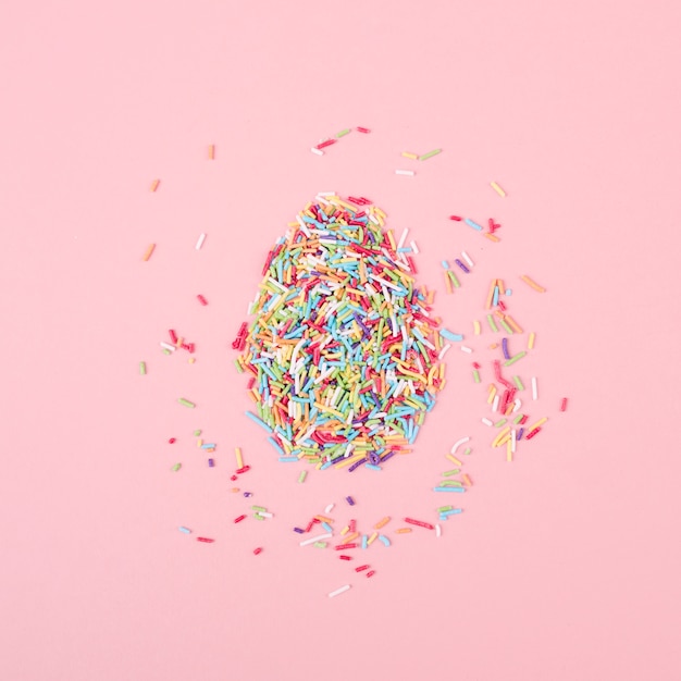 Free photo egg made of colorful sprinkles on table