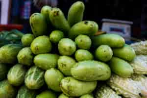 Free photo egg plant, cucumbers, and bitter gourd in a market in india