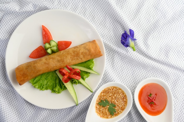 Free photo egg roll or fried spring rolls on the white plate thai food. top view.