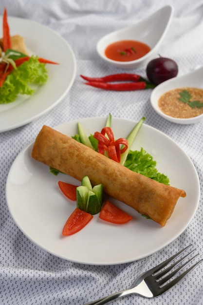 Free photo egg roll or fried spring rolls on the white plate thai food. .