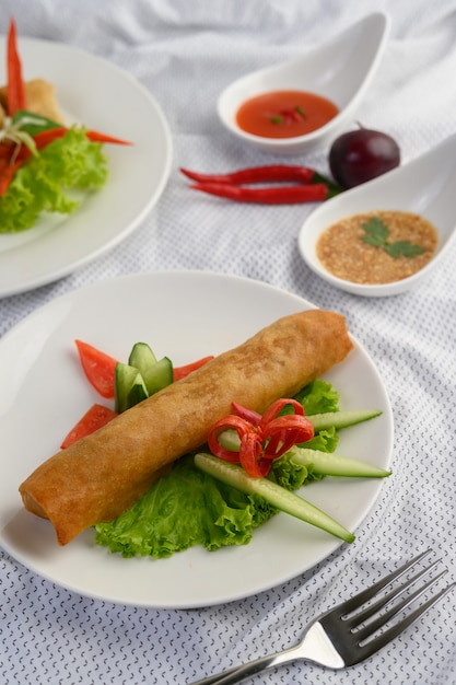 Free photo egg roll or fried spring rolls on the white plate thai food. .