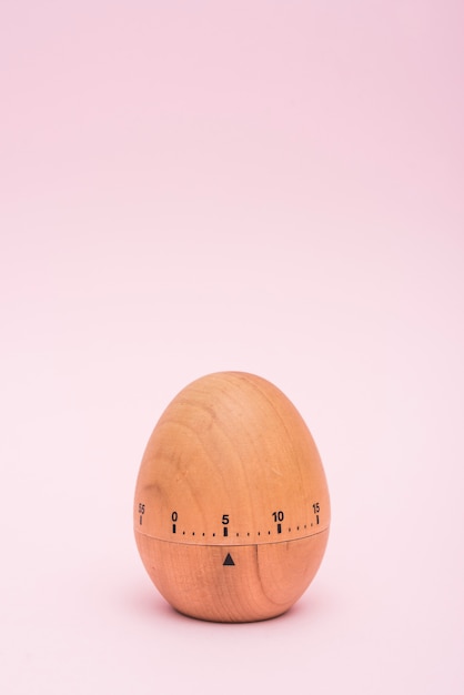 Free photo egg timer on pink background