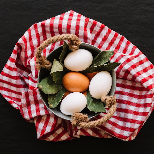 Eggs and bay leaves in saucepan