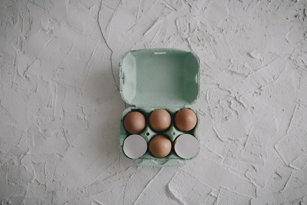 Eggs and eggshells in a box on the table