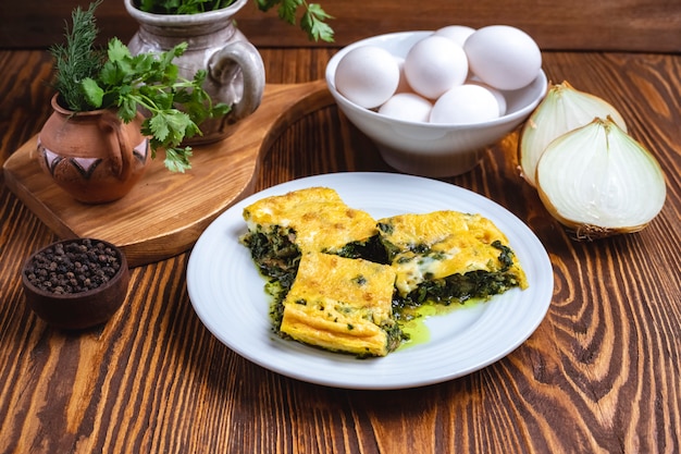 Eggs with spinach onion greens spices side view