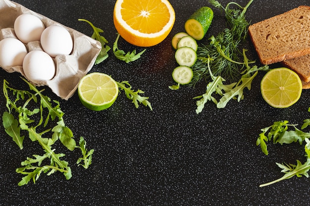 Free Photo eggs with vegetables and weeds on a black background