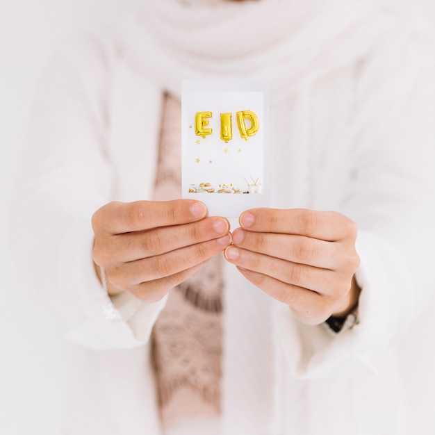 Free Photo eid al-fitr concept with hands showing card