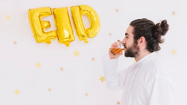 Free Photo eid al-fitr concept with man drinking tea