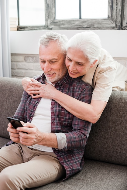 Elder couple using a smartphone