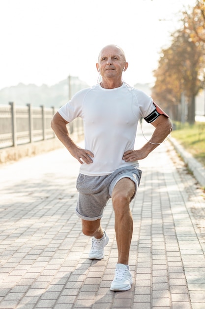 Elder man doing exercises outdoors