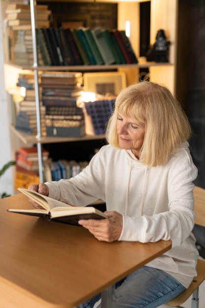 Elder woman reading a book at home