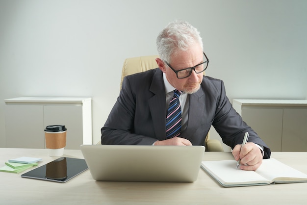 Elderly Businessman Focused on Work