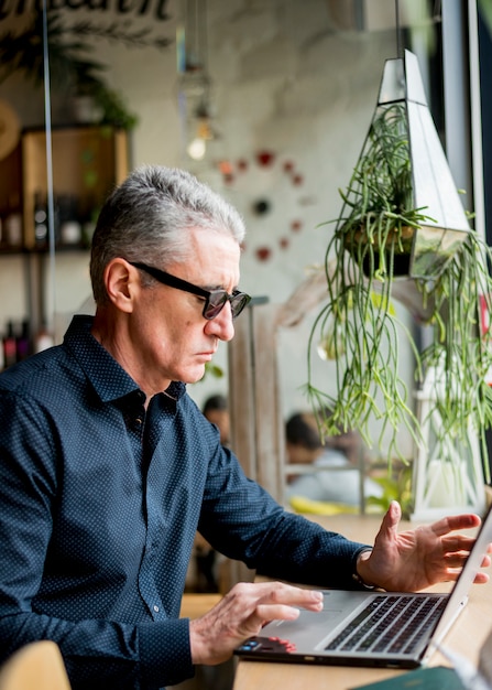 Elderly businessman using laptop