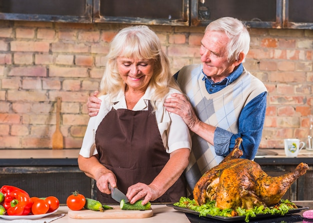 Elderly couple cooking turkey 